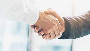 Handshake between two business people representing international coordination in frequency planning and ITU processes