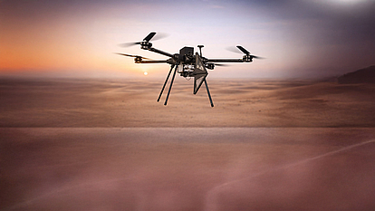 LS OBSERVER airborne monitoring unit drone Drone-based airborne monitoring unit for military spectrum monitoring above desert terrain.