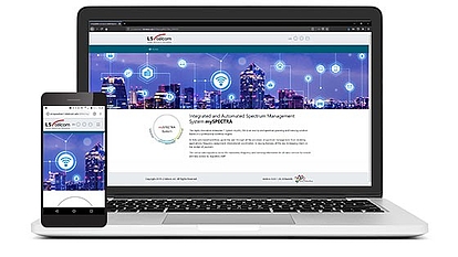 Responsive Spectrum Management System on Laptop and Smartphone A laptop and smartphone displaying the LS telcom website featuring an integrated and automated spectrum management system with a city skyline background and network icons.