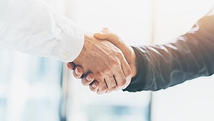 International Coordination - Frequency Planning and ITU Support Handshake between two business people representing international coordination in frequency planning and ITU processes