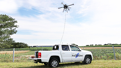Tethered AMU Drone for Extended Operations AMU drone tethered to a pick-up truck for continuous power and stable data connection during extended operations.